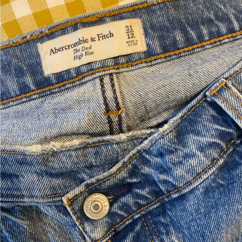 Abercrombie Dad High Rise cross over denim with raw hem.